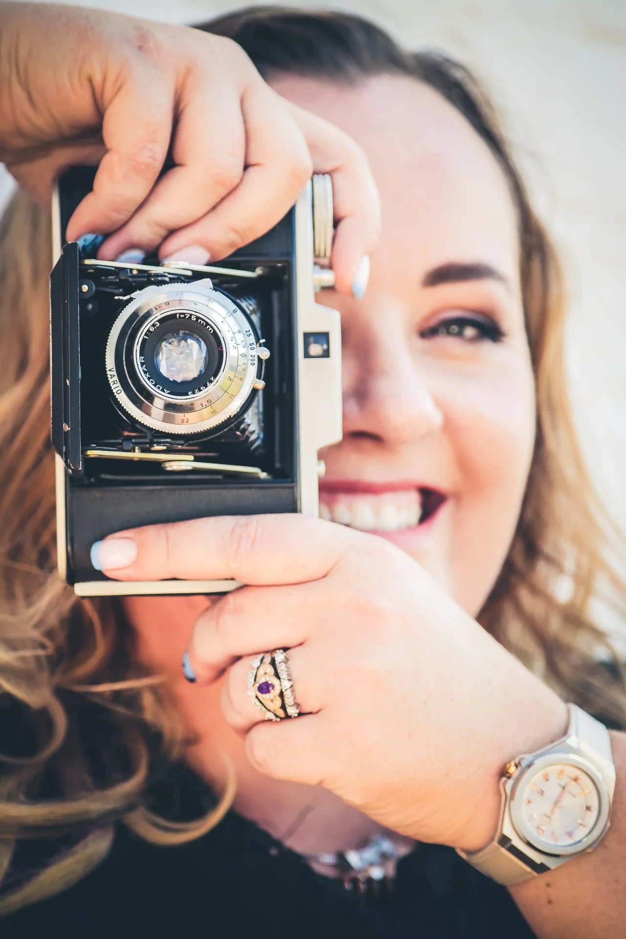 Nicole behind a vintage camera in 2025